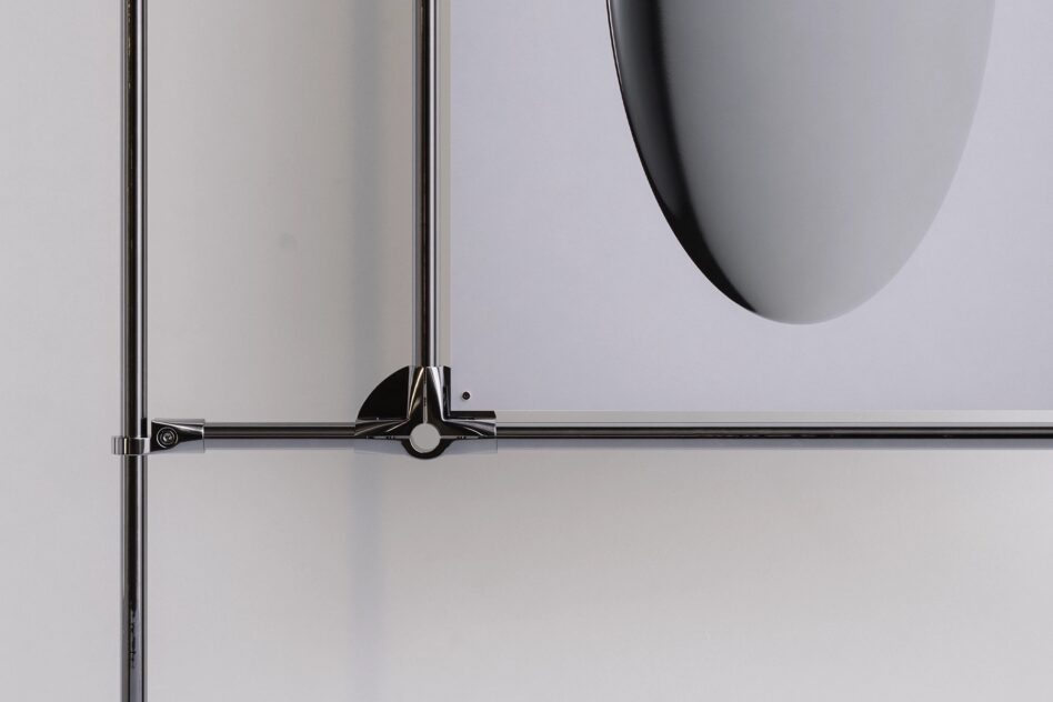 Single metal frame clamp holding blank poster against neutral wall
