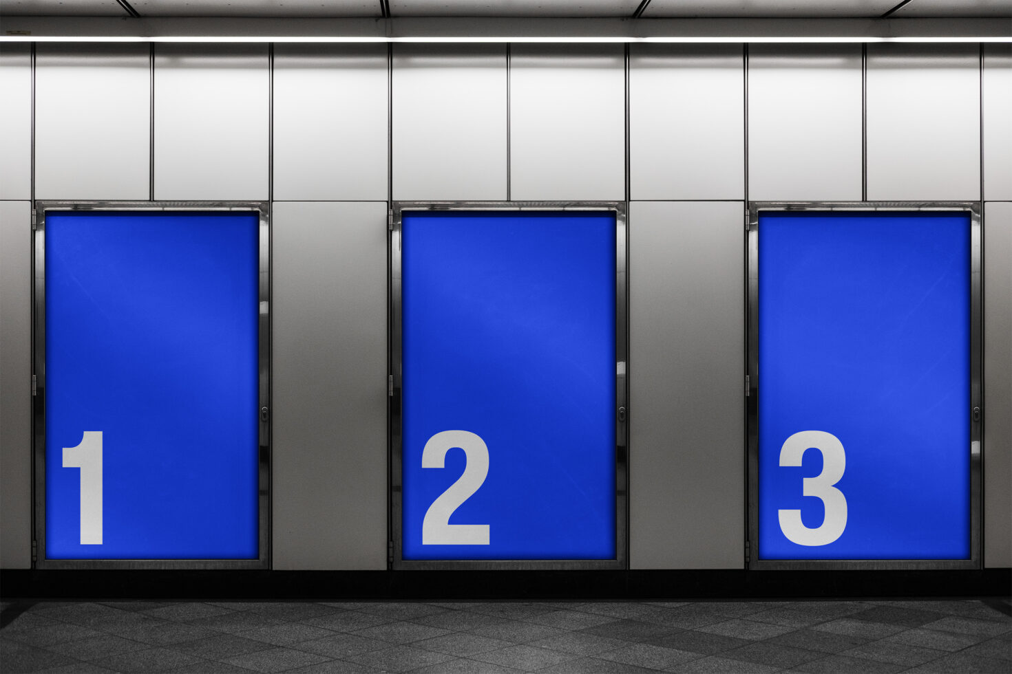 Cobalt blue poster mockups with white numbers displayed in underground passage