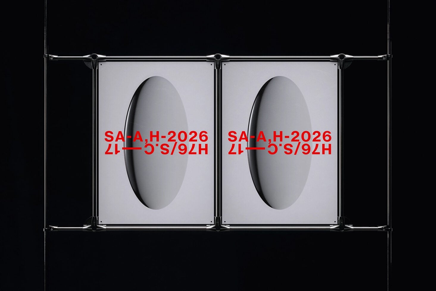 Metal clamp frame displaying two red text posters against dark backdrop