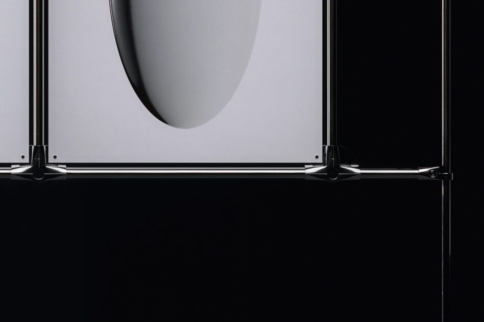 Low angle view of metal frame clamp holding poster with oval detail