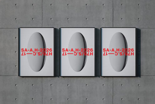 Three framed prints showing 3D spheres with red text overlay on concrete