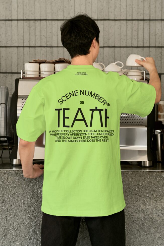 Person wearing bright lime shirt from behind standing at kitchen counter