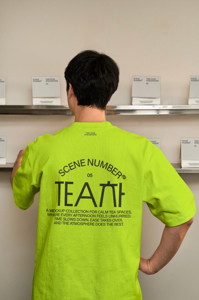 Person wearing lime tee from back in front of shelf with product boxes