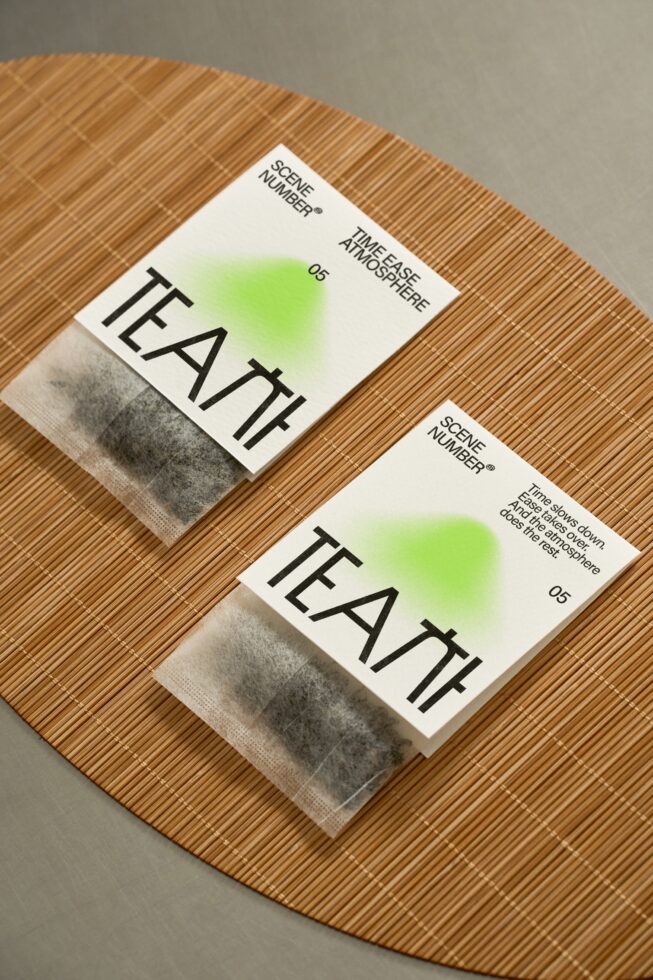 Two tea packet mockups on woven placemat with green gradient covers showing TEATH branding