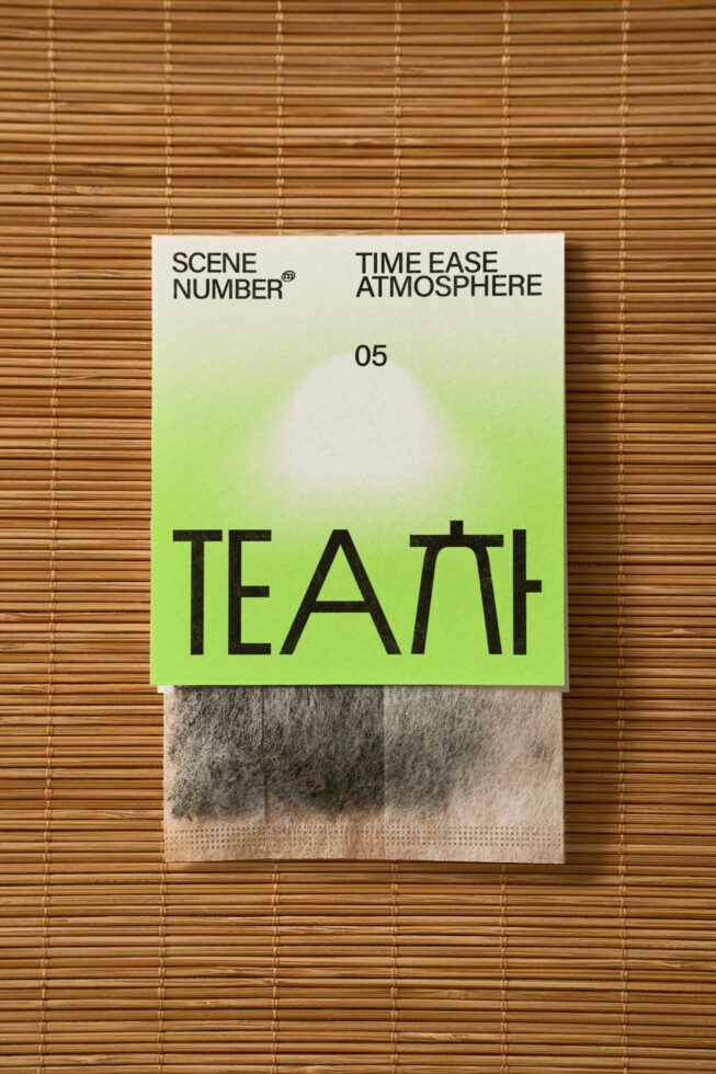 Tea packaging on bamboo placemat with vibrant neon gradient cover TEATH design