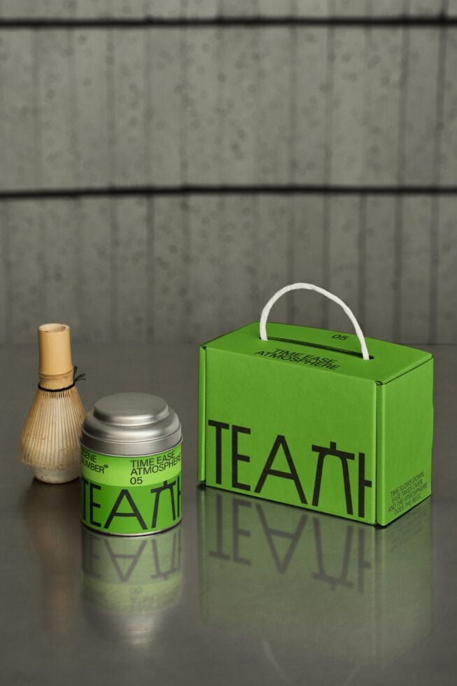 Green tea tin, bamboo whisk, silver canister, box with white handle on concrete