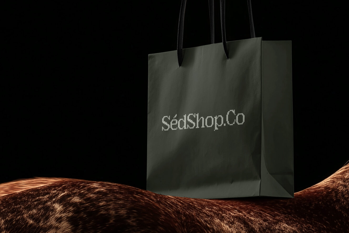 Sage green tote bag with black handles displayed against dark background