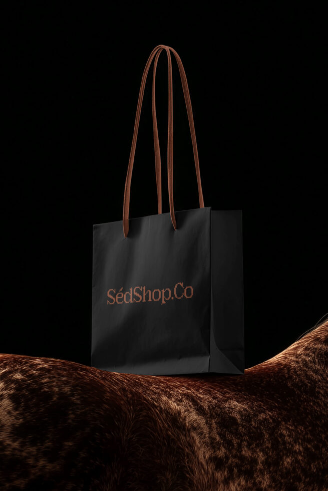 Black tote bag with leather handles, copper SédShop.Co logo on front