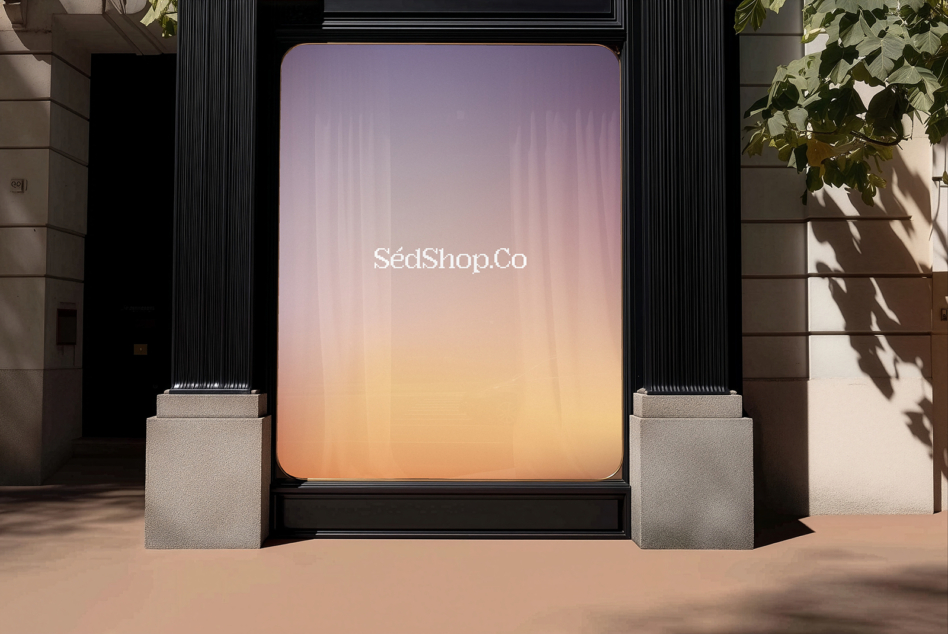 Luxury storefront with gradient sunset display, soft pink to orange glow, minimal branding