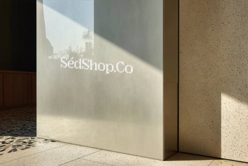 SedShop.Co branding on neutral wall with diagonal light creating depth