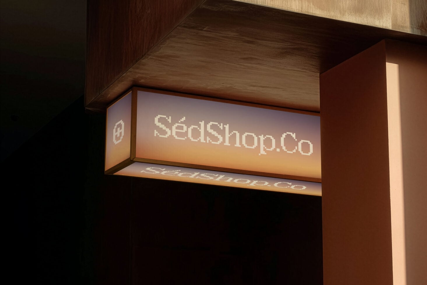Lit storefront sign mockup displaying SedShop.Co with gentle warm lighting glow