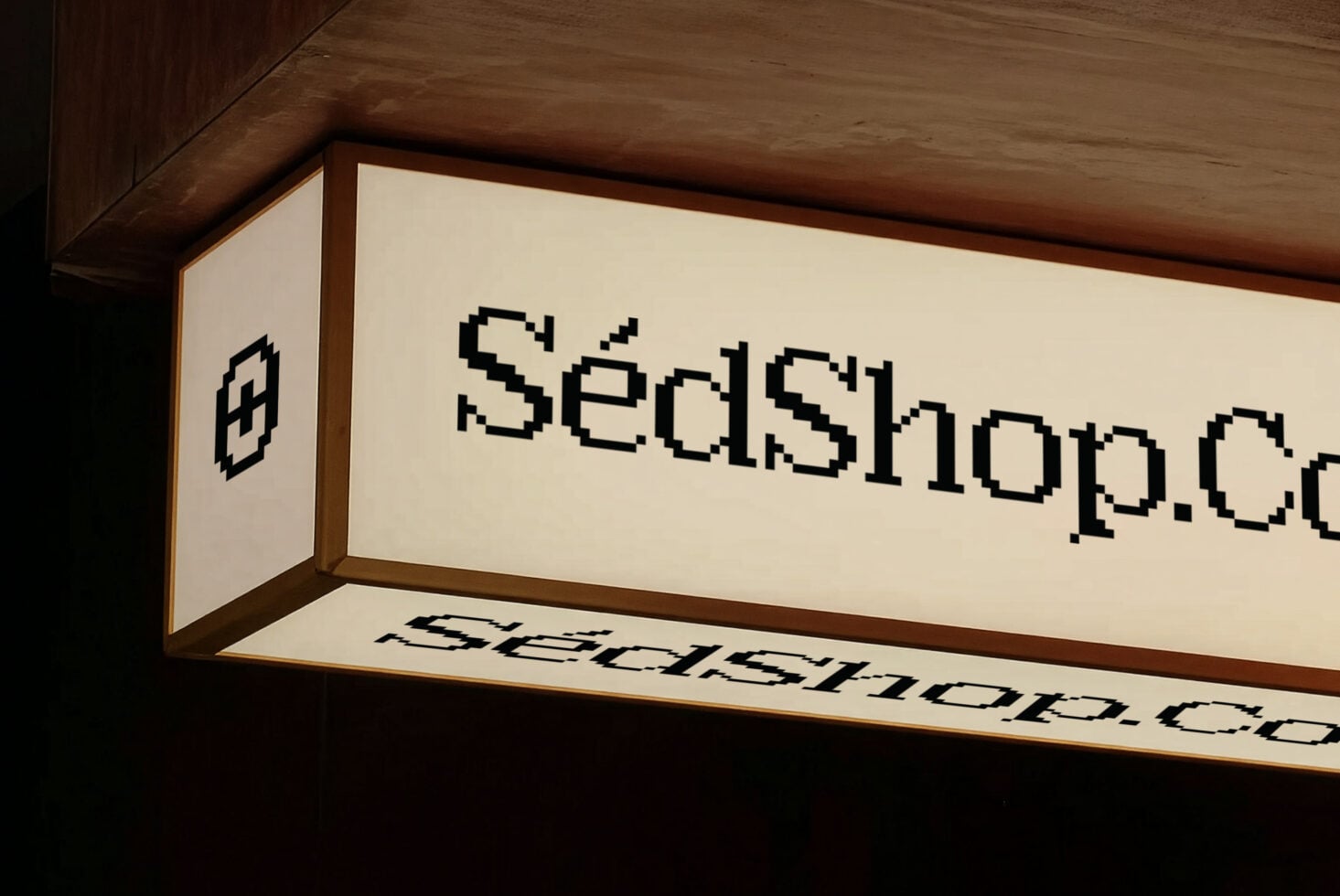 Illuminated horizontal storefront sign displaying SedShop.Co in blocky retro lettering