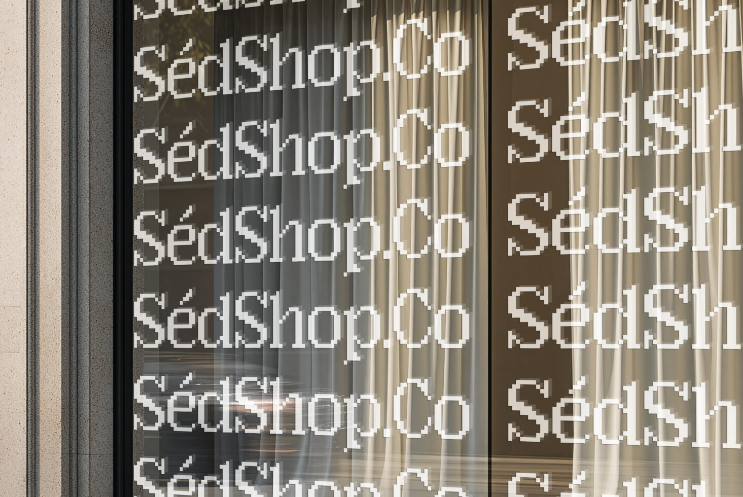 Storefront window mockup showing repeating serif shop text on glass