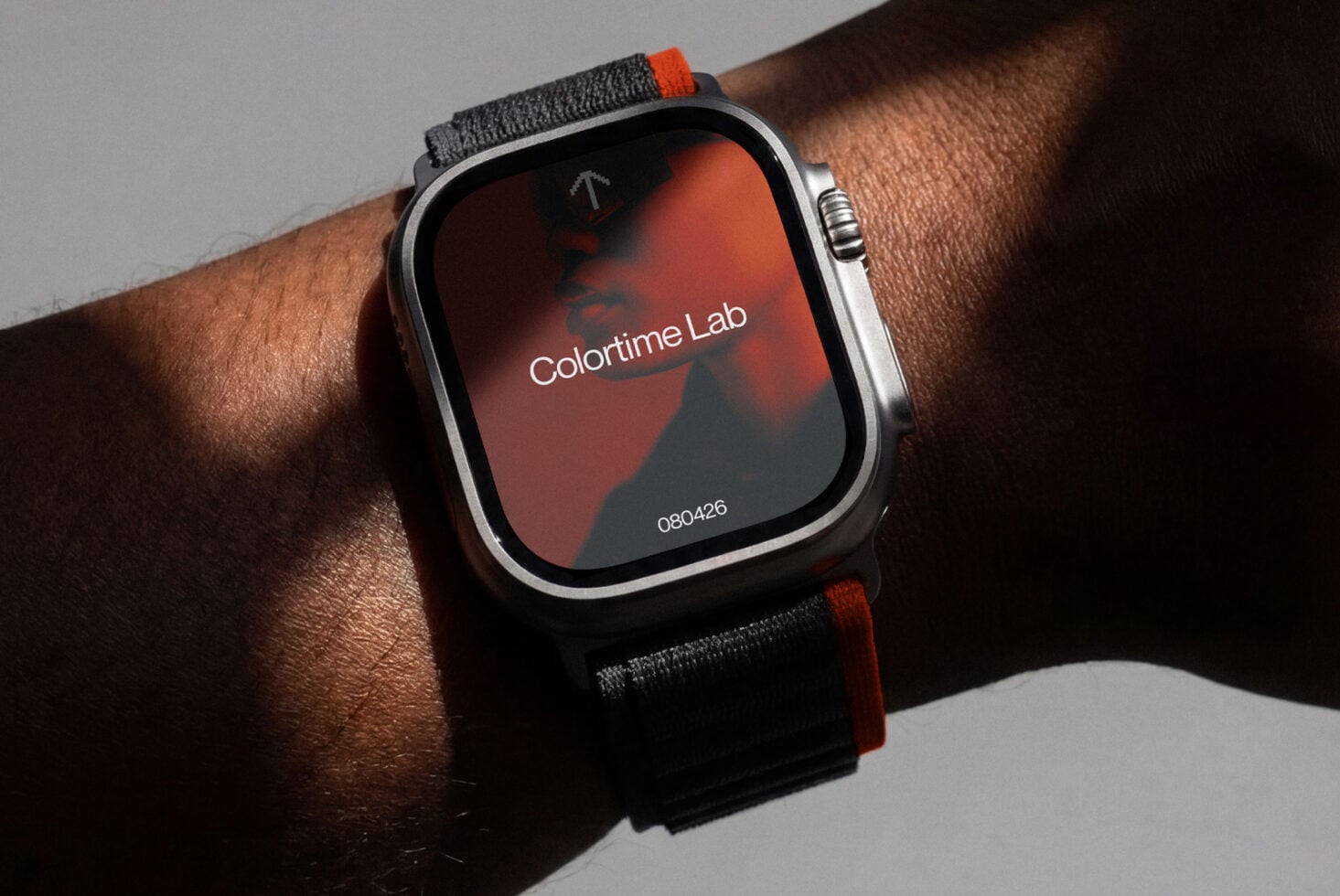 Smartwatch on wrist with neon accent band displaying colorful gradient