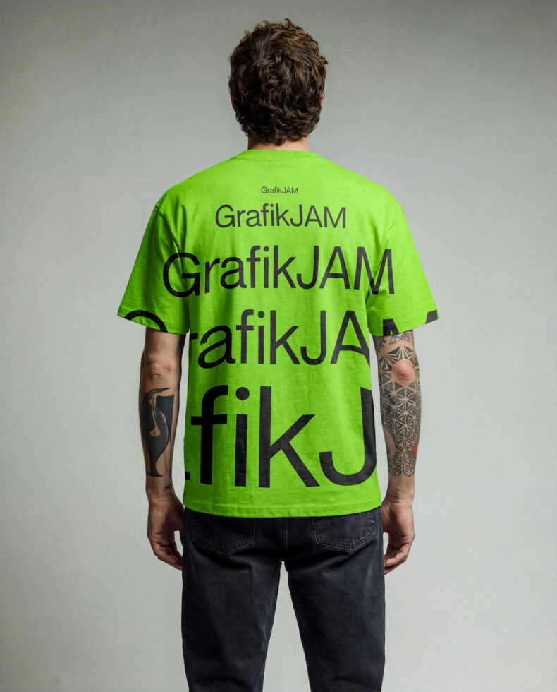 Back view of person wearing bright green tee with large GrafikJAM text overlay