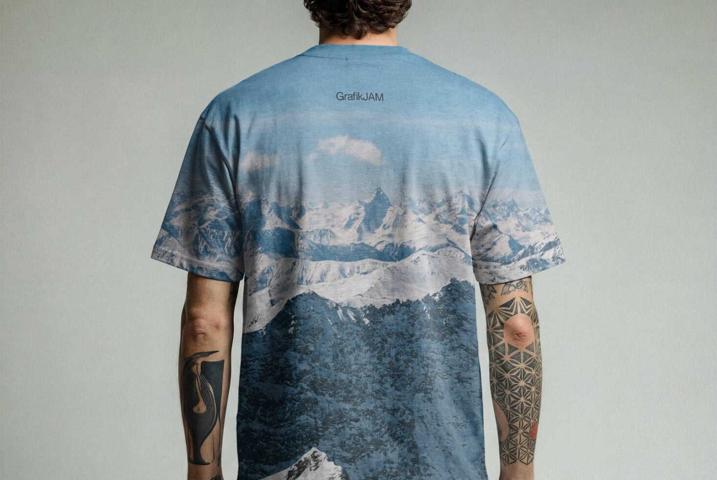 Blue t-shirt with snowy mountain landscape print on back