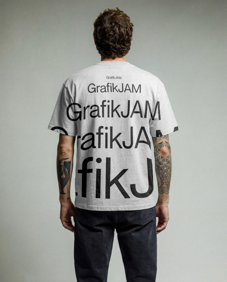 Back view of cream tee with repeated GrafikJAM text pattern across shirt