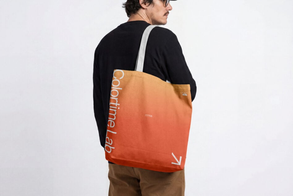 Gradient orange tote bag worn on person's back with white strap visible