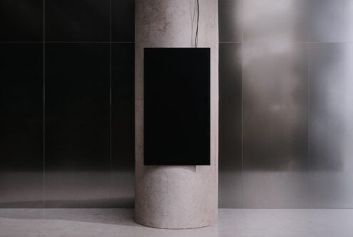 Blank poster mockup on concrete column in minimalist space