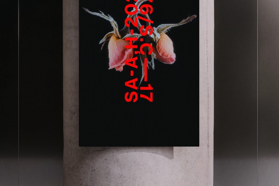 Red text overlay on dried flower poster against concrete wall