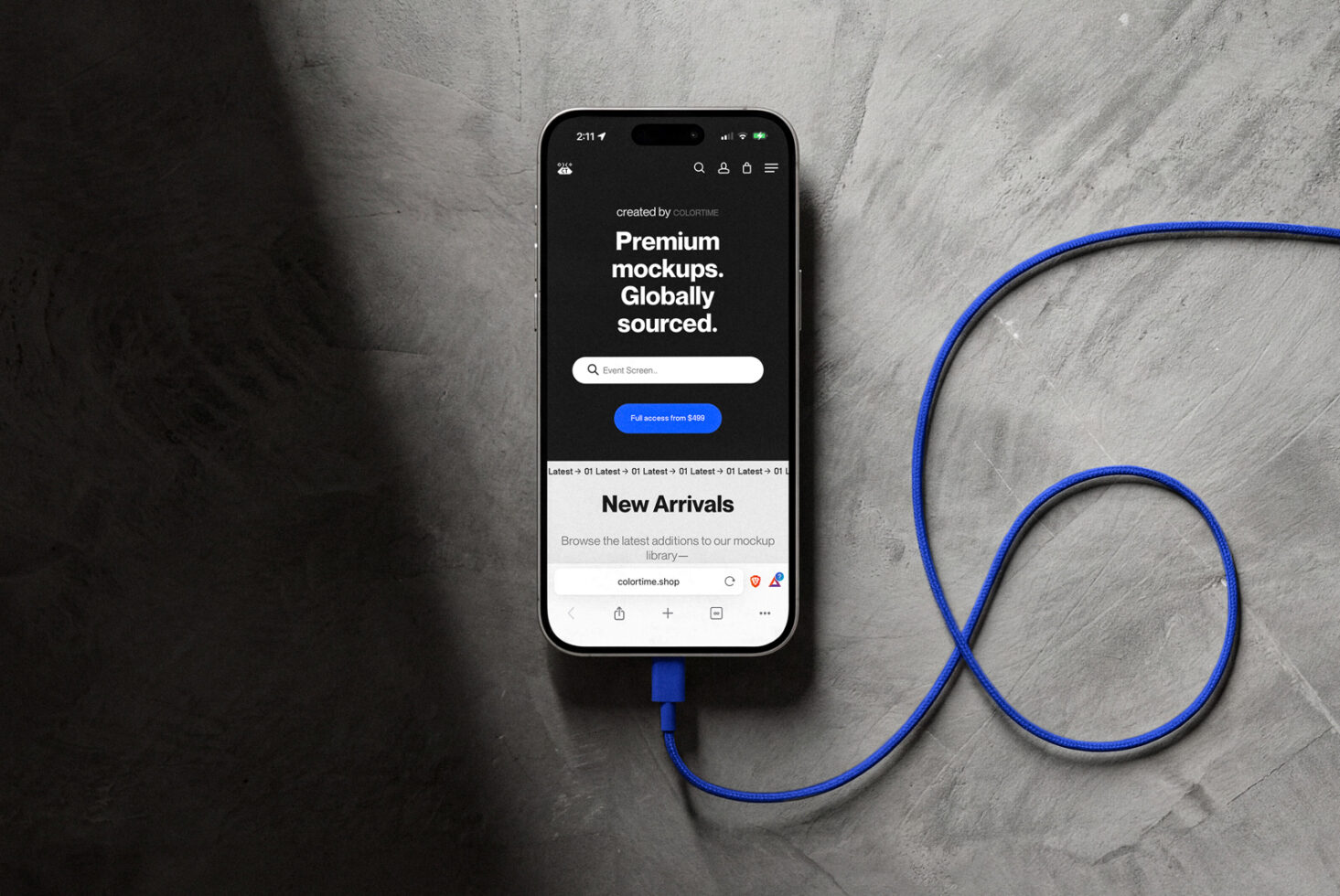 iPhone showing Colortime marketplace with premium mockups, blue charging cable on concrete