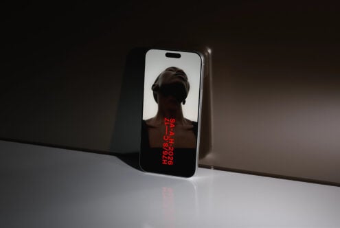 Phone mockup showing portrait silhouette with red diagonal text overlay on display