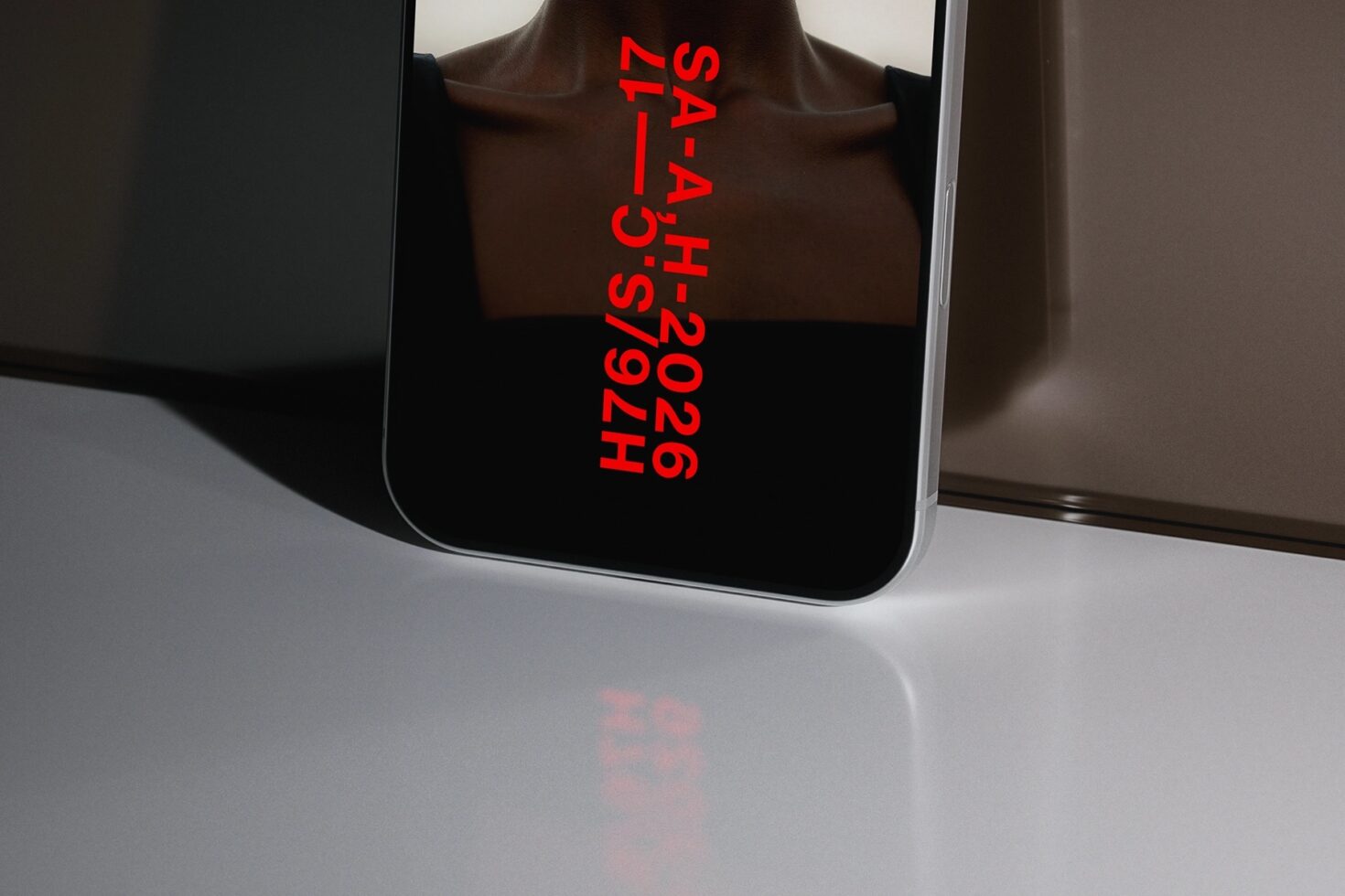 Phone screen displaying bright red vertical text hash code on black background