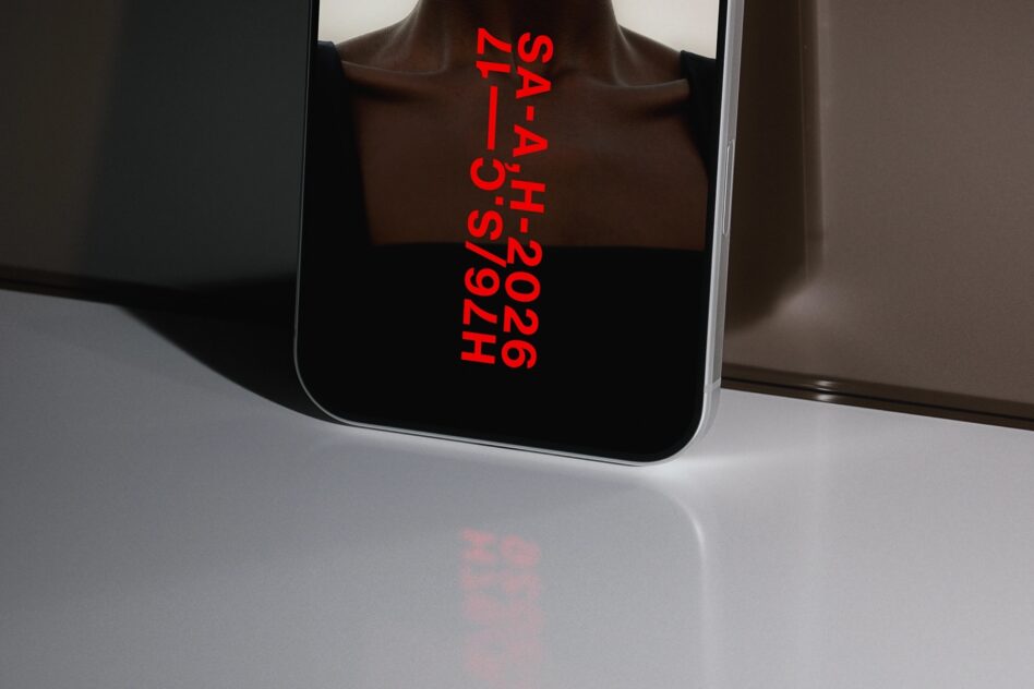 Phone screen displaying bright red vertical text hash code on black background
