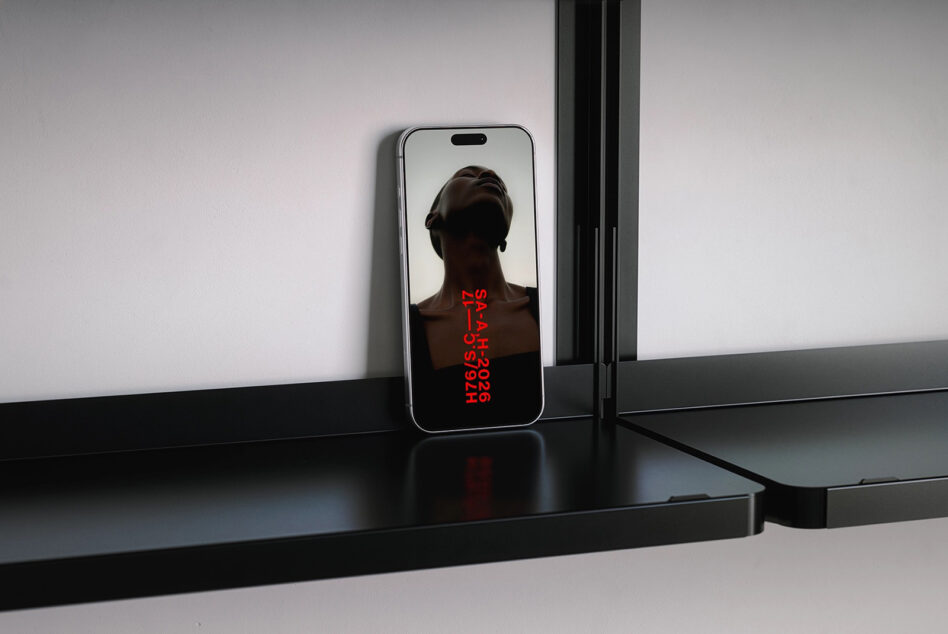 Phone displaying red vertical text SAAAH2026 H76IS over figure silhouette