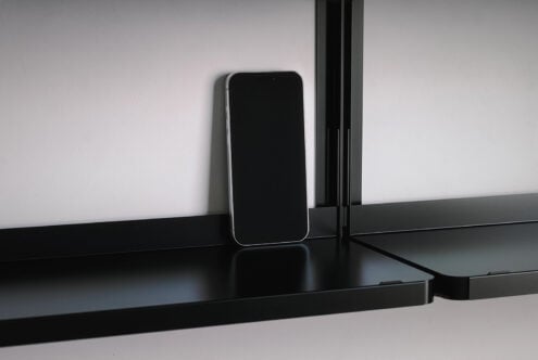 Smartphone on black desk standing empty with notch visible
