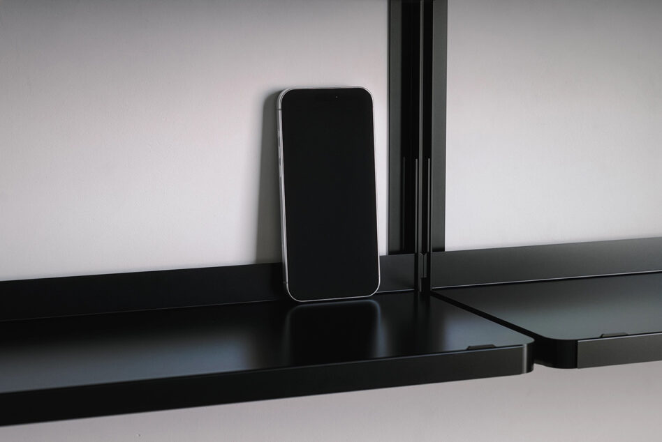 Smartphone on black desk standing empty with notch visible