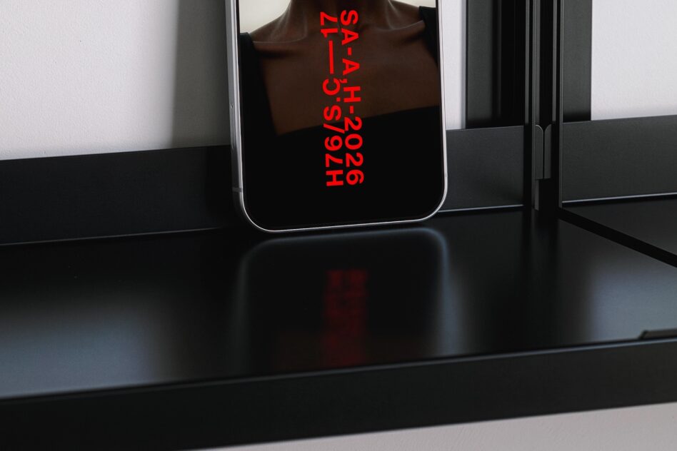 Phone tilted showing red vertical text SAAAH2026 H76IS with silhouette