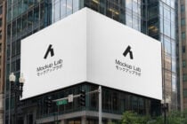 Corner building billboard mockup with Mockup Lab logo on urban street
