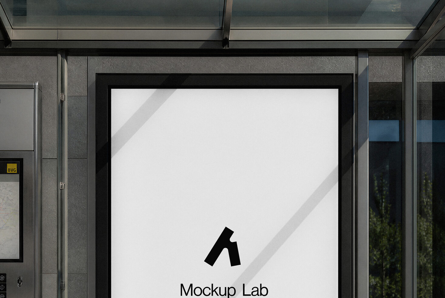 Storefront window mockup with black frame showing blank white poster, sunlight casting diagonal shadows