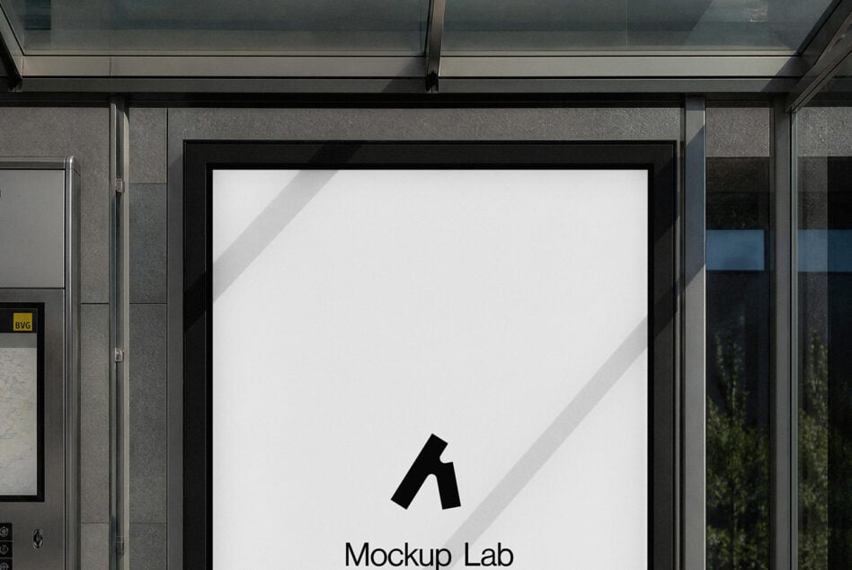 Storefront window mockup with black frame showing blank white poster, sunlight casting diagonal shadows