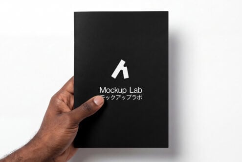Hand holding black card mockup with white Mockup Lab mark in center