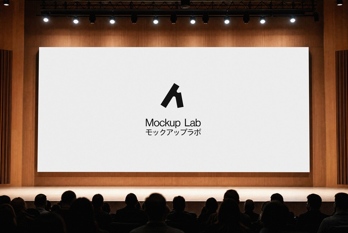 Large cinema screen displaying Mockup Lab logo in warm wood interior with crowd