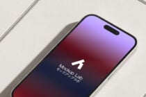 Black-notch phone closeup showing purple to pink gradient on screen with logo