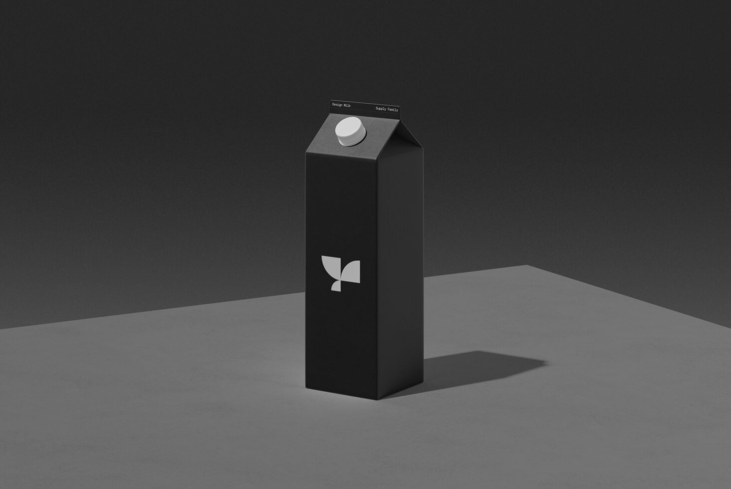 Tall black milk carton mockup with white cap, geometric leaf logo on front, minimal studio setup