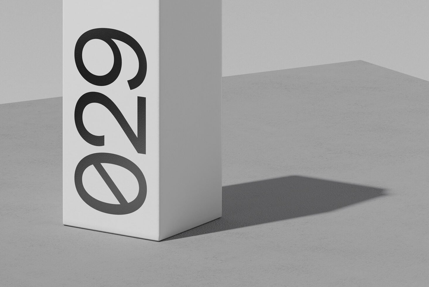 White box mockup with bold black geometric logo casting sharp shadow on gray surface