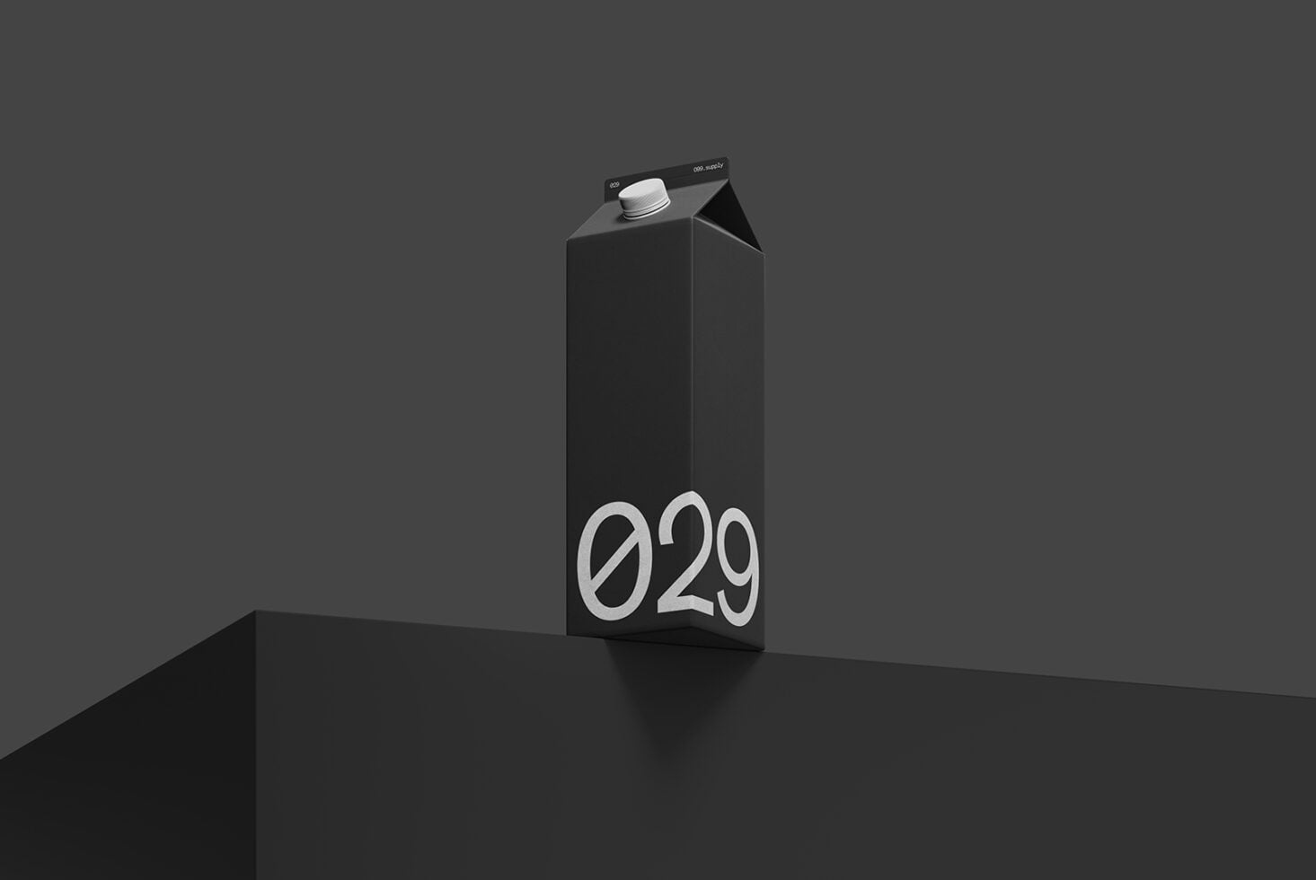 Black carton mockup with "029" branding on dark minimal platform background