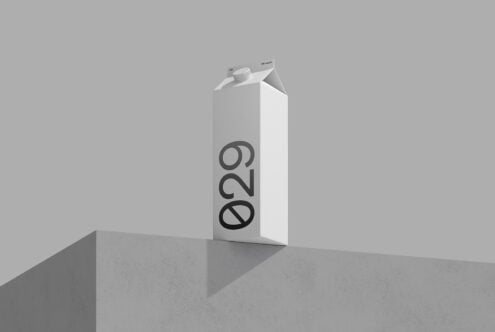 Tall white carton mockup with bold number design on concrete platform, grey background