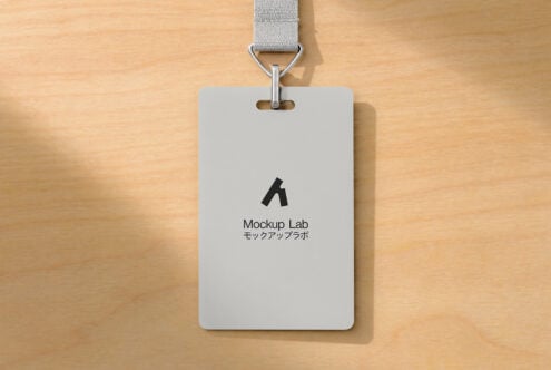 ID badge mockup with gray fabric lanyard on wooden background