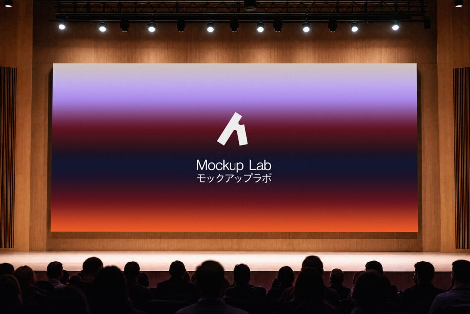 Theater projection screen showing purple to orange gradient with audience below