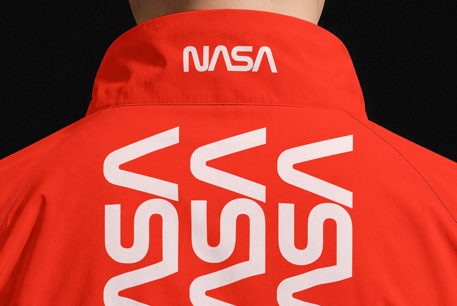 Red jacket back view with NASA logo on collar, large wavy pattern across back