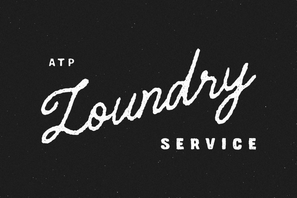 Grungy cursive lettering spelling ATP Laundry Service on dark textured backdrop
