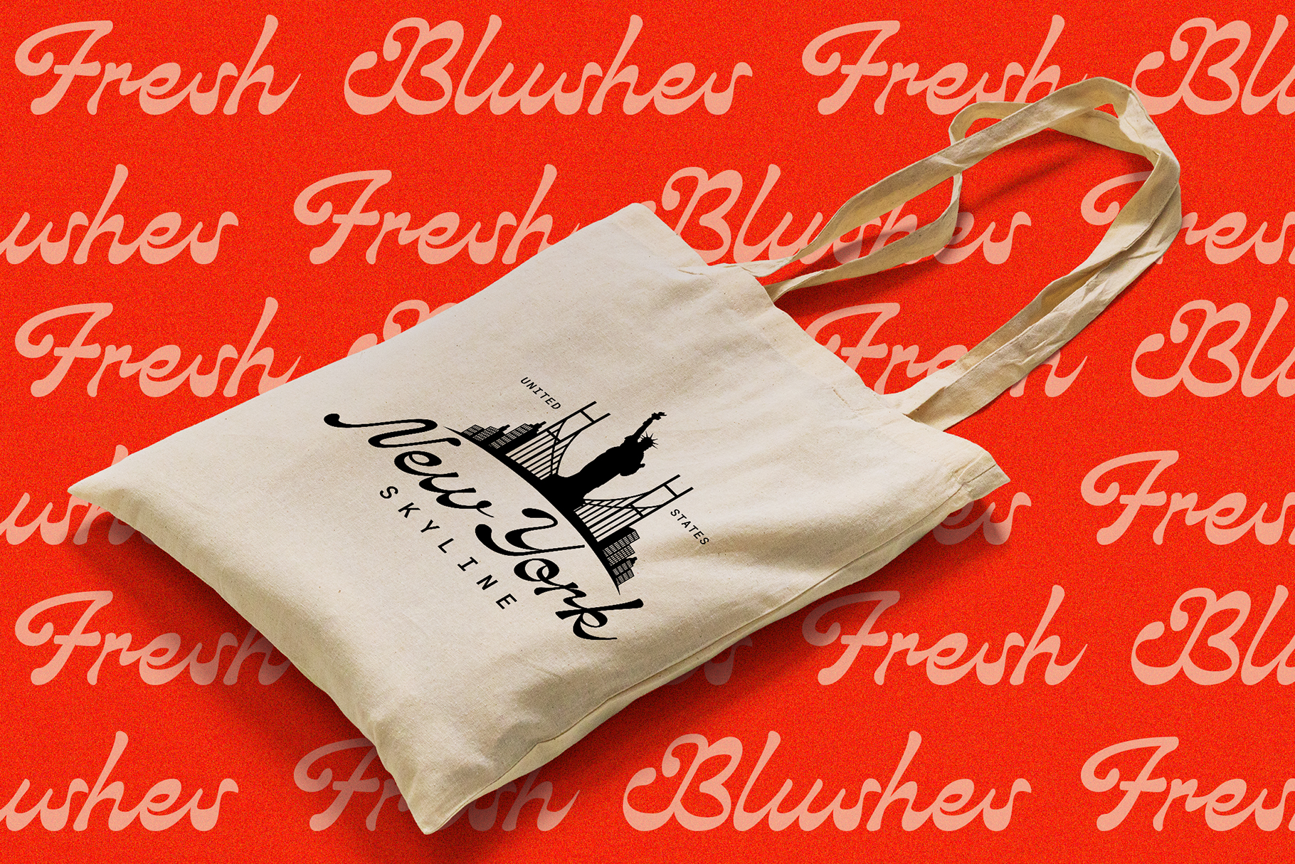 Cream canvas tote bag with Fresh Blusher script logo skyline design on red
