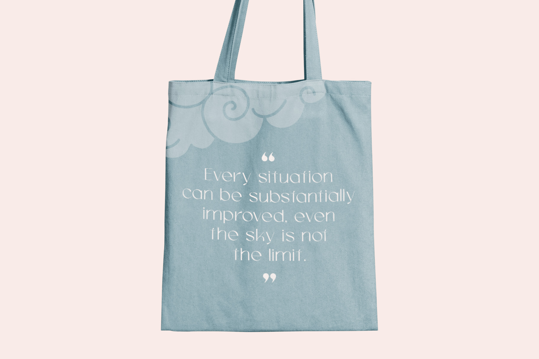 Blue tote bag with inspirational quote printed in white serif font