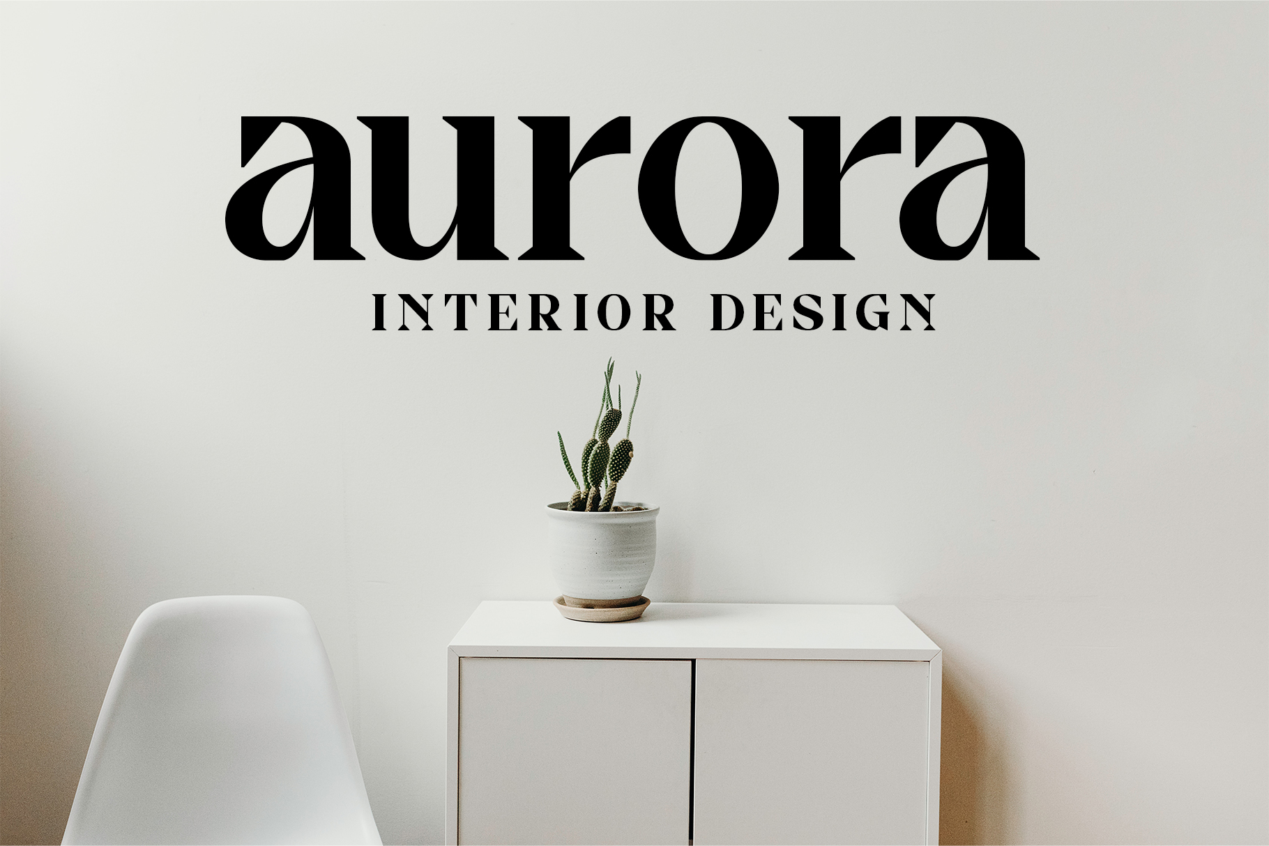 Modern minimalist wall decal reading Aurora Interior Design above small potted cactus