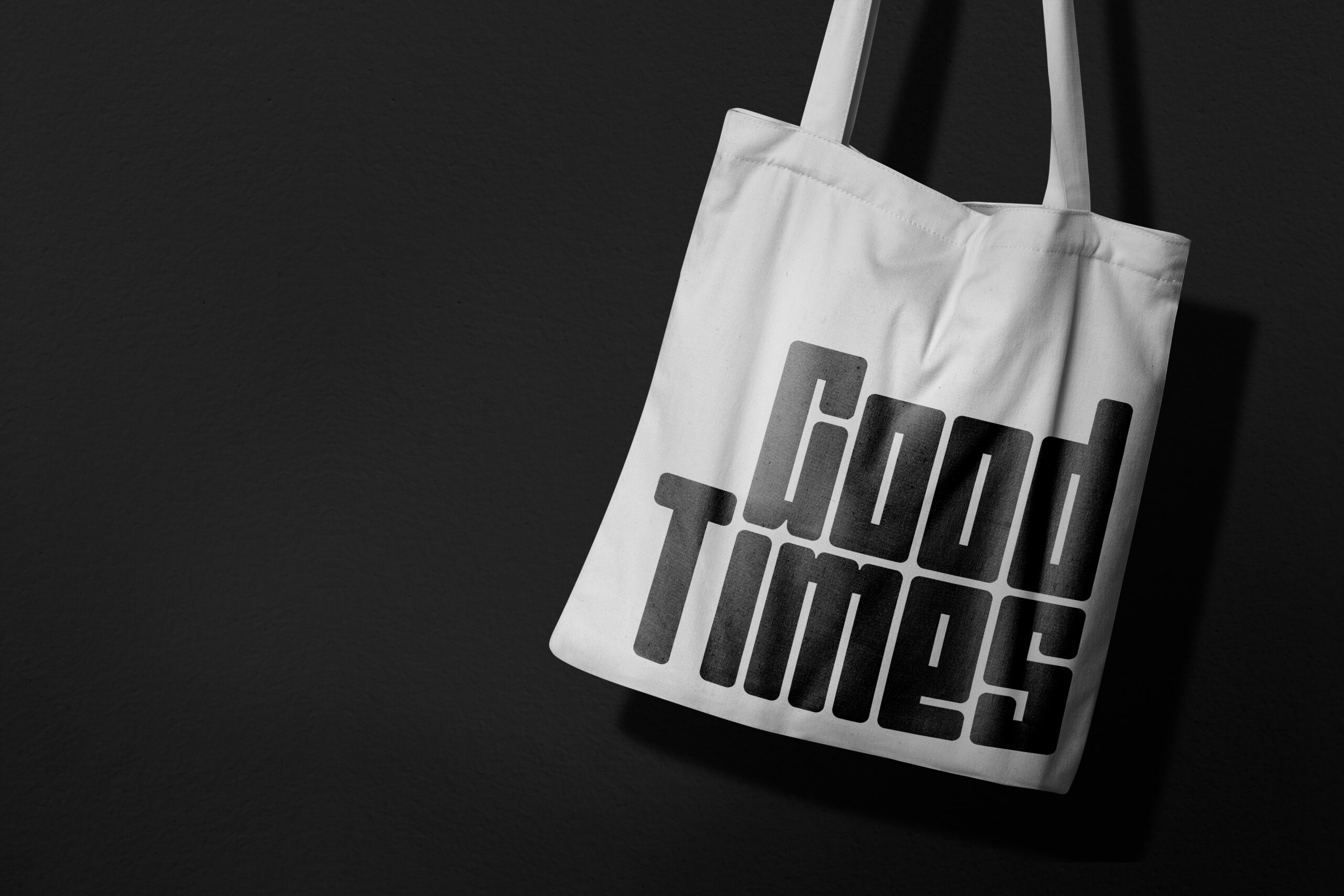 White canvas tote bag with geometric stacked text design mockup